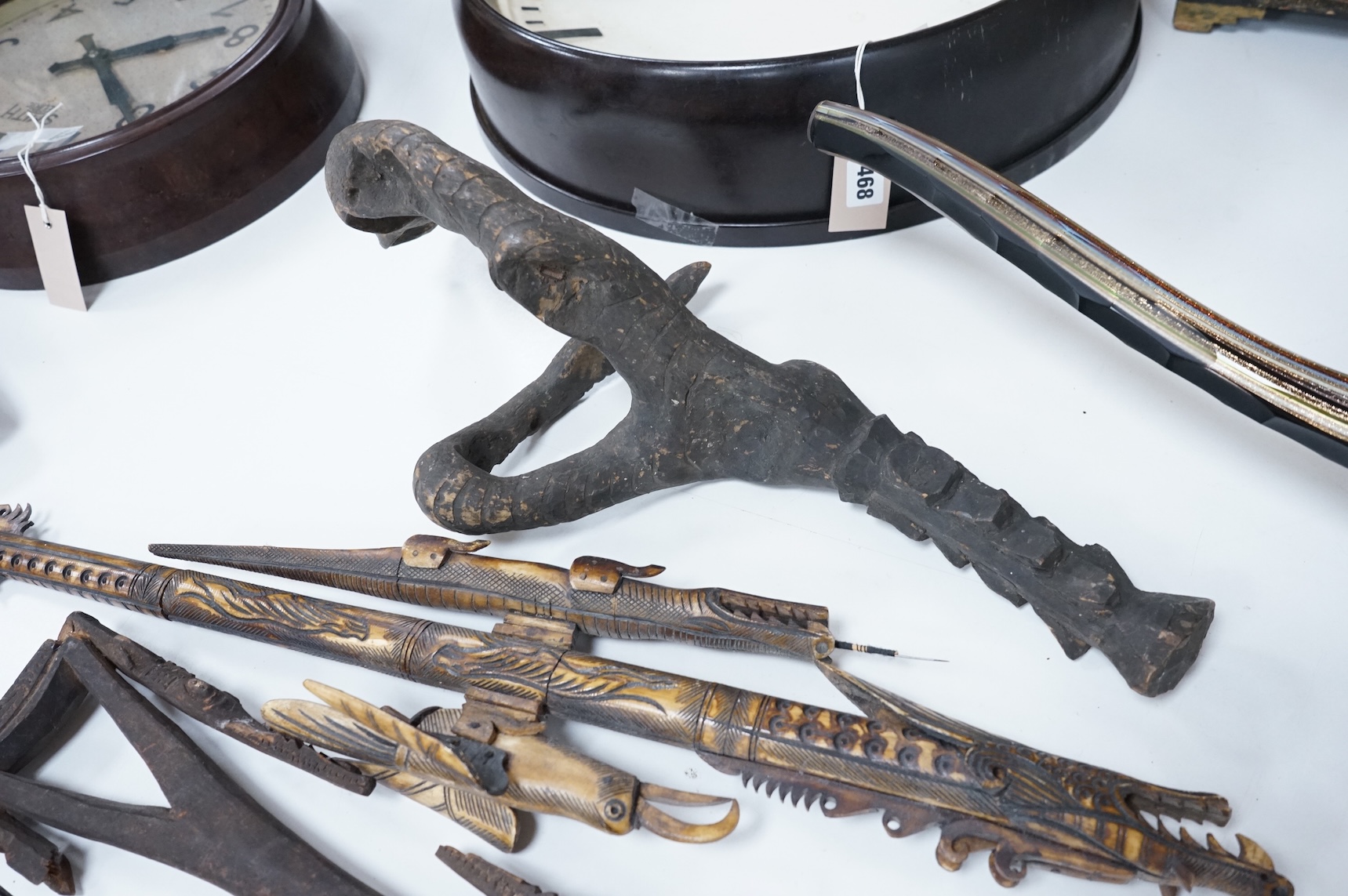 Two Papua New Guinea Sepik River carvings and a carved bone artefact, largest 92cm in length